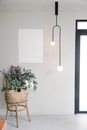 Bouquet of fresh wildflowers in wicker basket placed near wall with white mockup