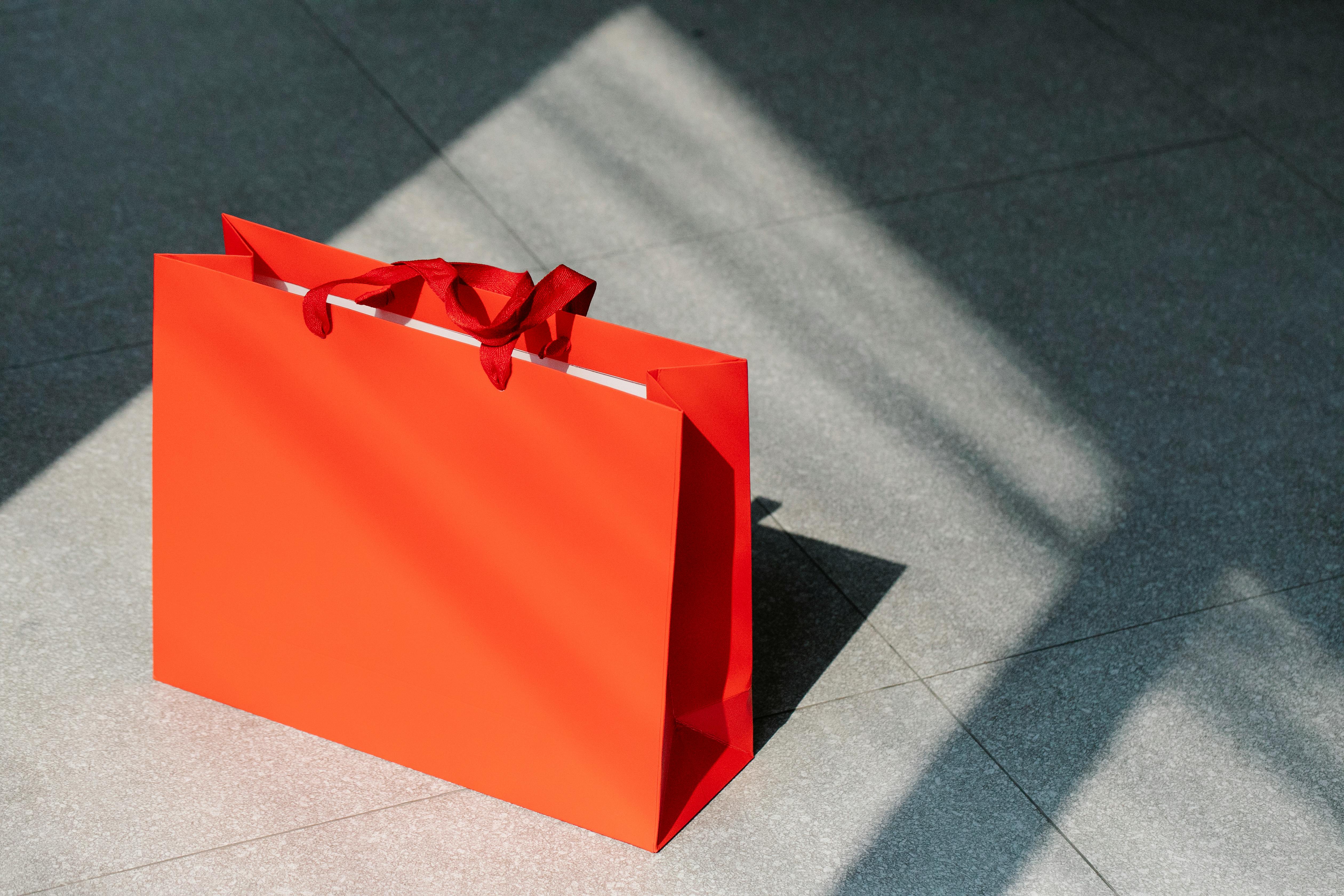 Red paper shopping bags on floor · Free Stock Photo