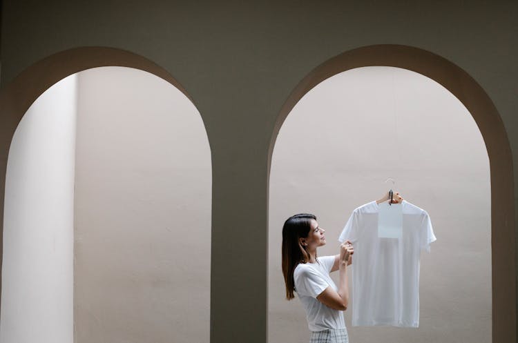 Trendy Young Woman Demonstrating White T Shirt Near Arched Passage