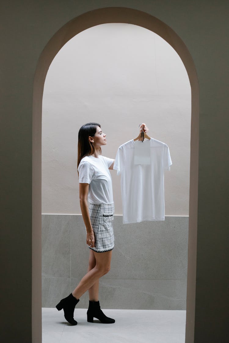 Woman Standing In Corridor With White T Shirt