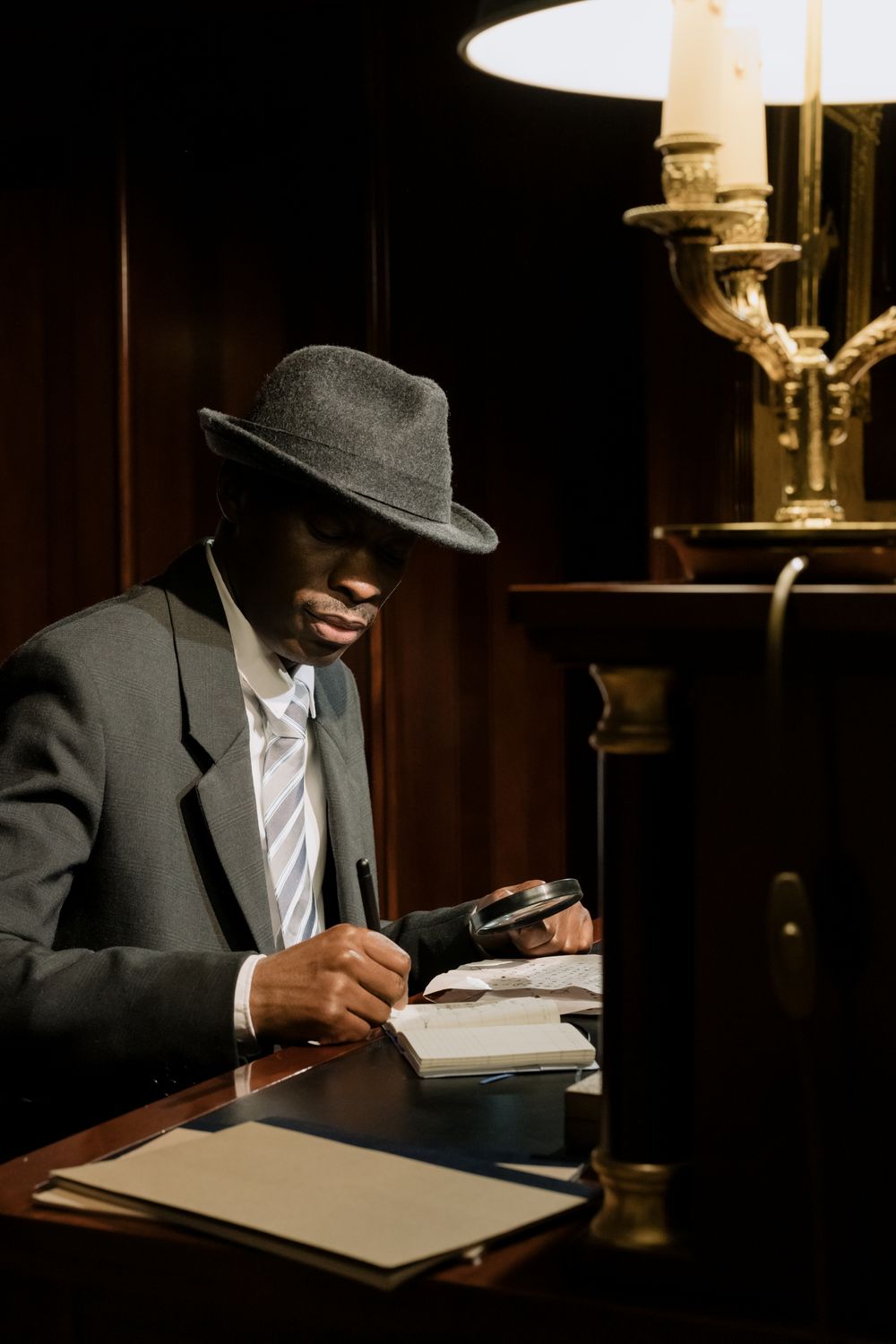 Investigator taking written notes in a dimly lit office