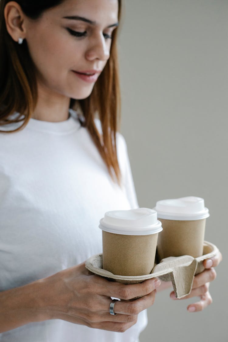 Woman Carrying Paper Holder With Hot Drinks