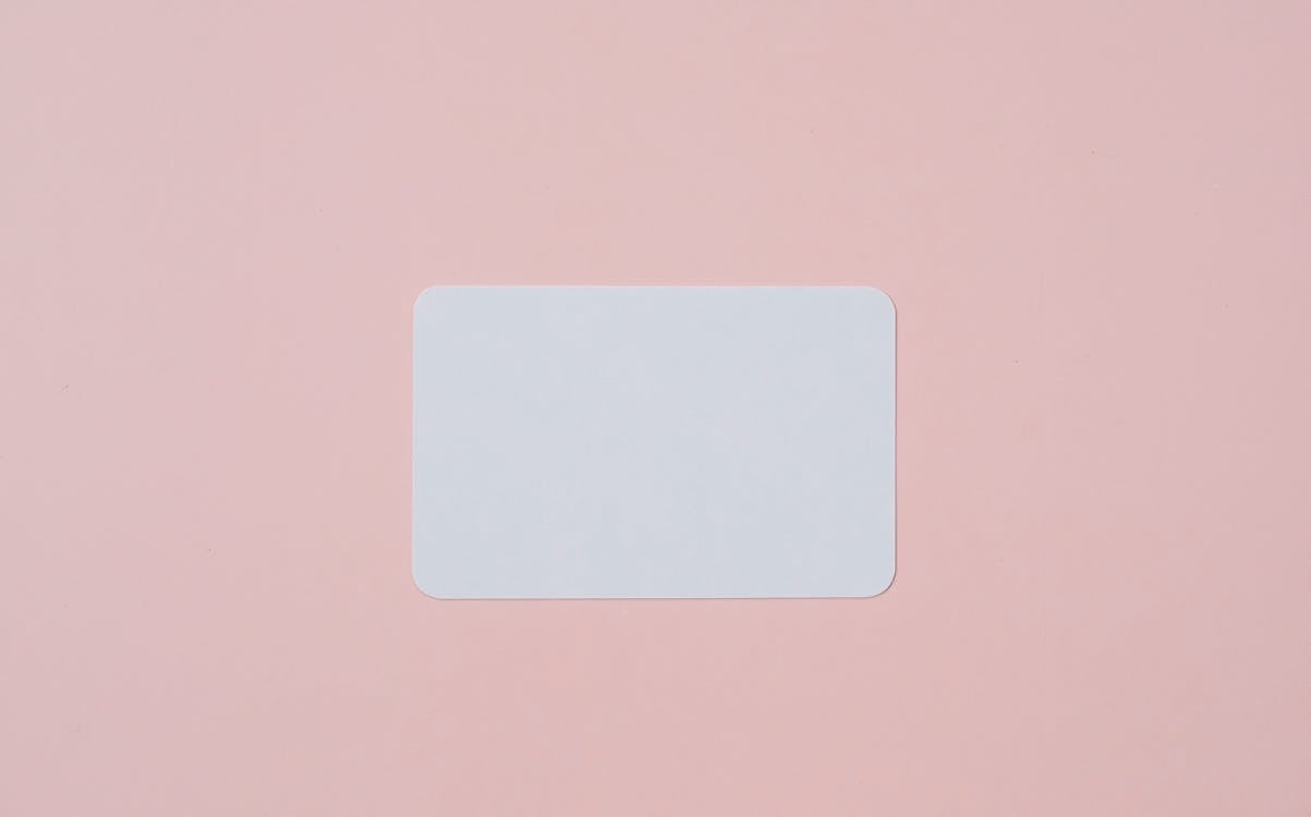 Blank visiting card on pink background · Free Stock Photo