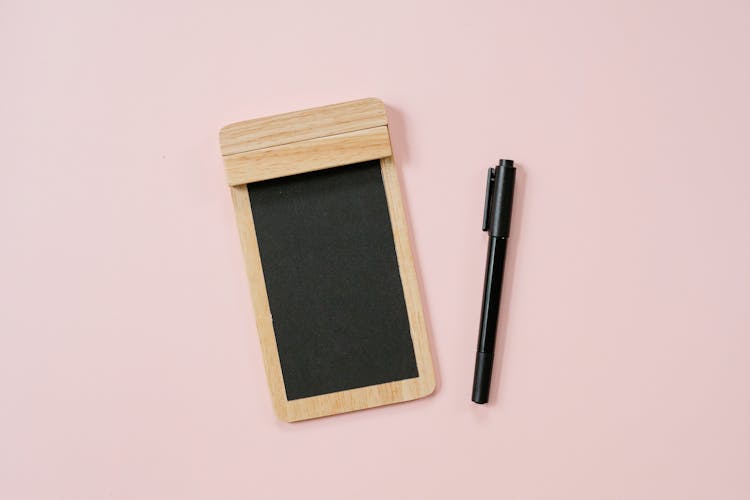 Pen And Wooden Notepad With Black Paper