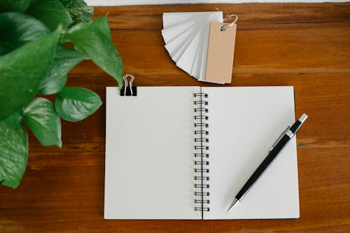 Free Notepad and pen near tags and plant Stock Photo