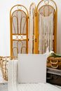 White blank canvas placed against vintage suitcases and classic folding screen in light room
