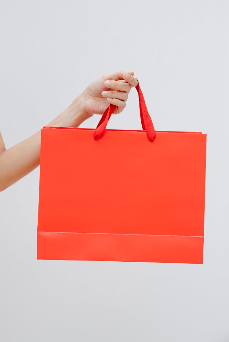 Crop Anonymous Woman Demonstrating Red Shopping Bag