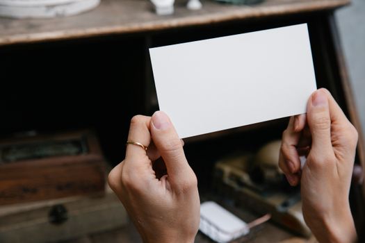 Crop unrecognizable woman showing blank card