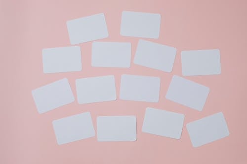 Set of empty white papers attached on pink wall