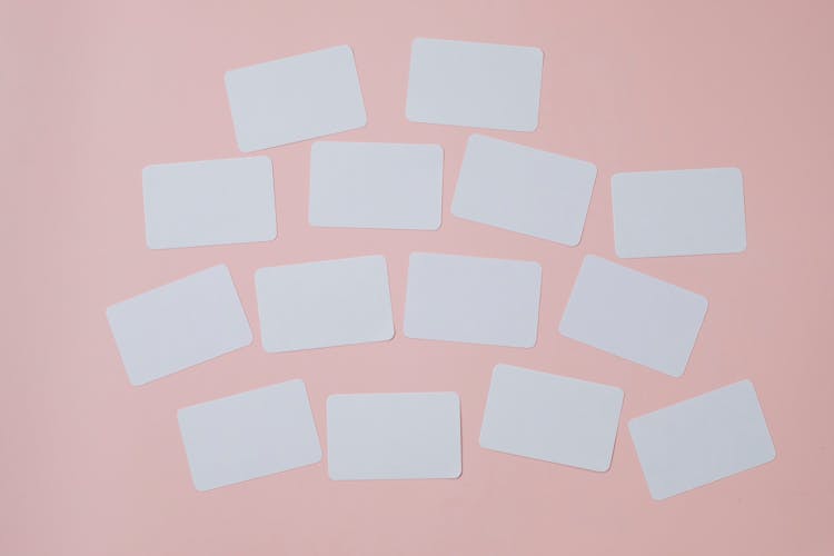 Set Of Empty White Papers Attached On Pink Wall