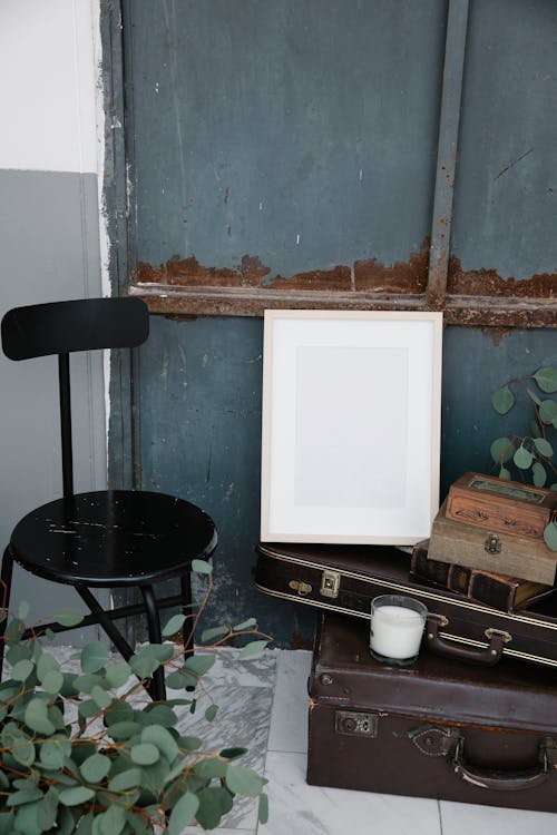 Empty frame placed on old fashioned suitcases