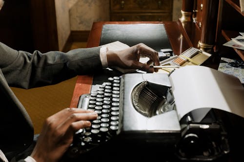 Photo of Person Using Vintage Typewriter