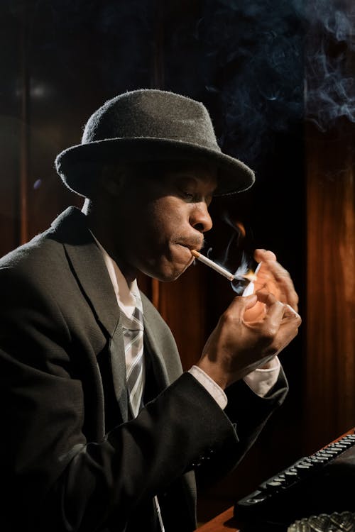 Free Photo of Man in Black Suit Smoking Cigarette Stock Photo