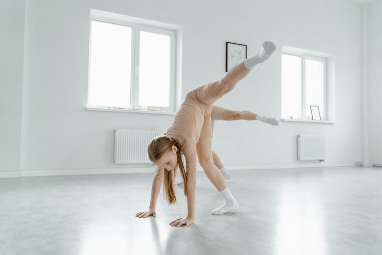 Girls Stretching Their Legs Upward