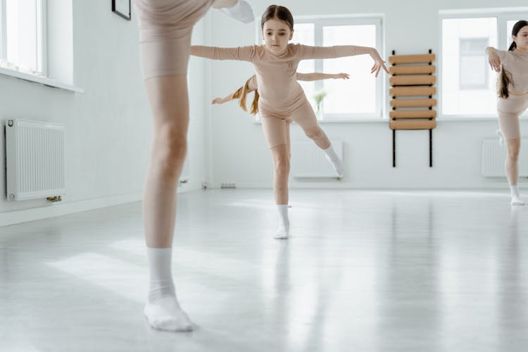 Girls Stretching Their Legs Backwards