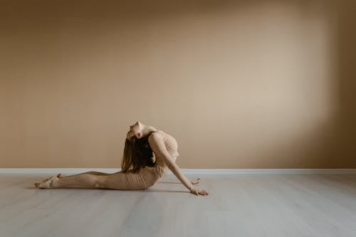 Woman Stretching Her Body on the Floor 