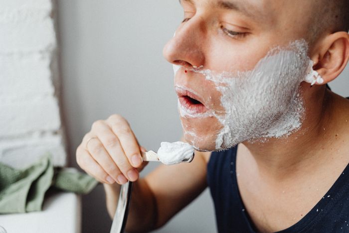 Close view of lather being brushed onto a jawline. Photo by Kaboompics on Pexels