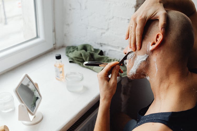 Man Shaving Himself