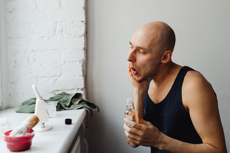 Man Using An After Shave 