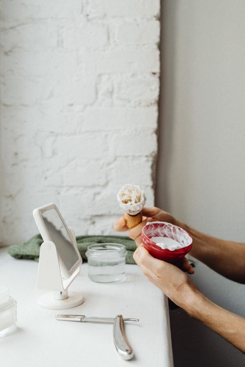 Free Hands preparing to shave with brush and cream next to a razor. Stock Photo