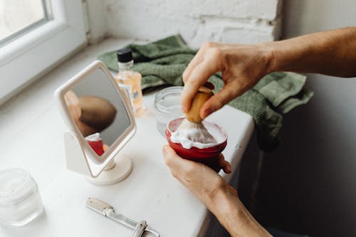 Closr-up of Man Dipping a Brush in Shaving Cream 