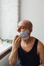 Man in Blue Tank Top Applying Shaving Cream on Face
