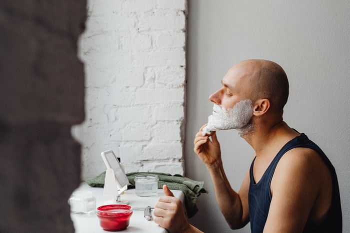 Lathering up at a bathroom counter in morning light. Photo by Kaboompics on Pexels