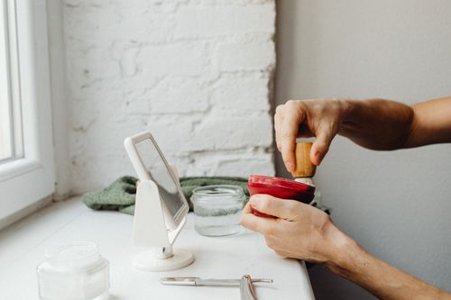 Free A man's hands prepare shaving cream using a brush by a window. Stock Photo