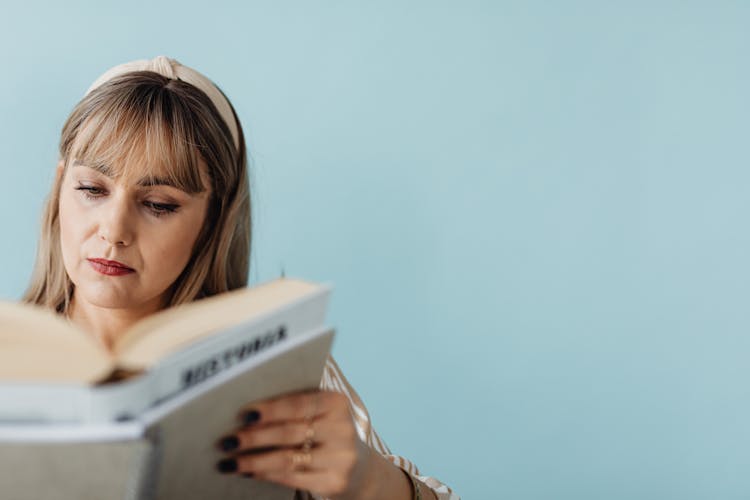 Focused Woman Reading A Book 