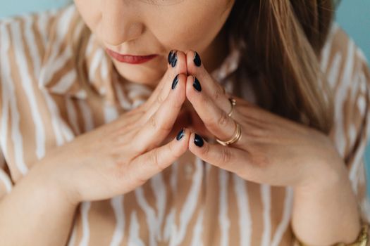 Woman with her Fingertips Together 