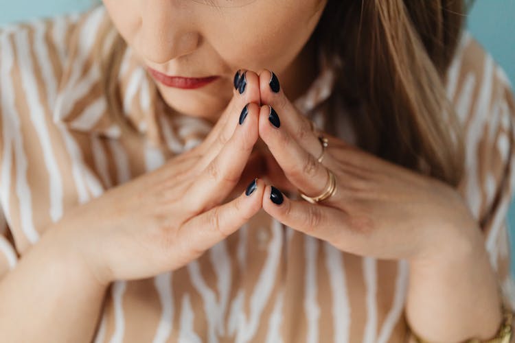 Woman With Her Fingertips Together 