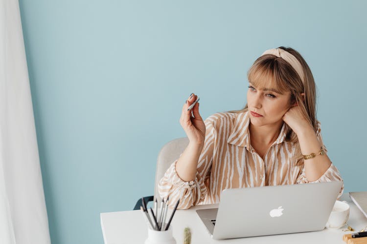 Woman Absentmindedly Fidgeting With Pencil