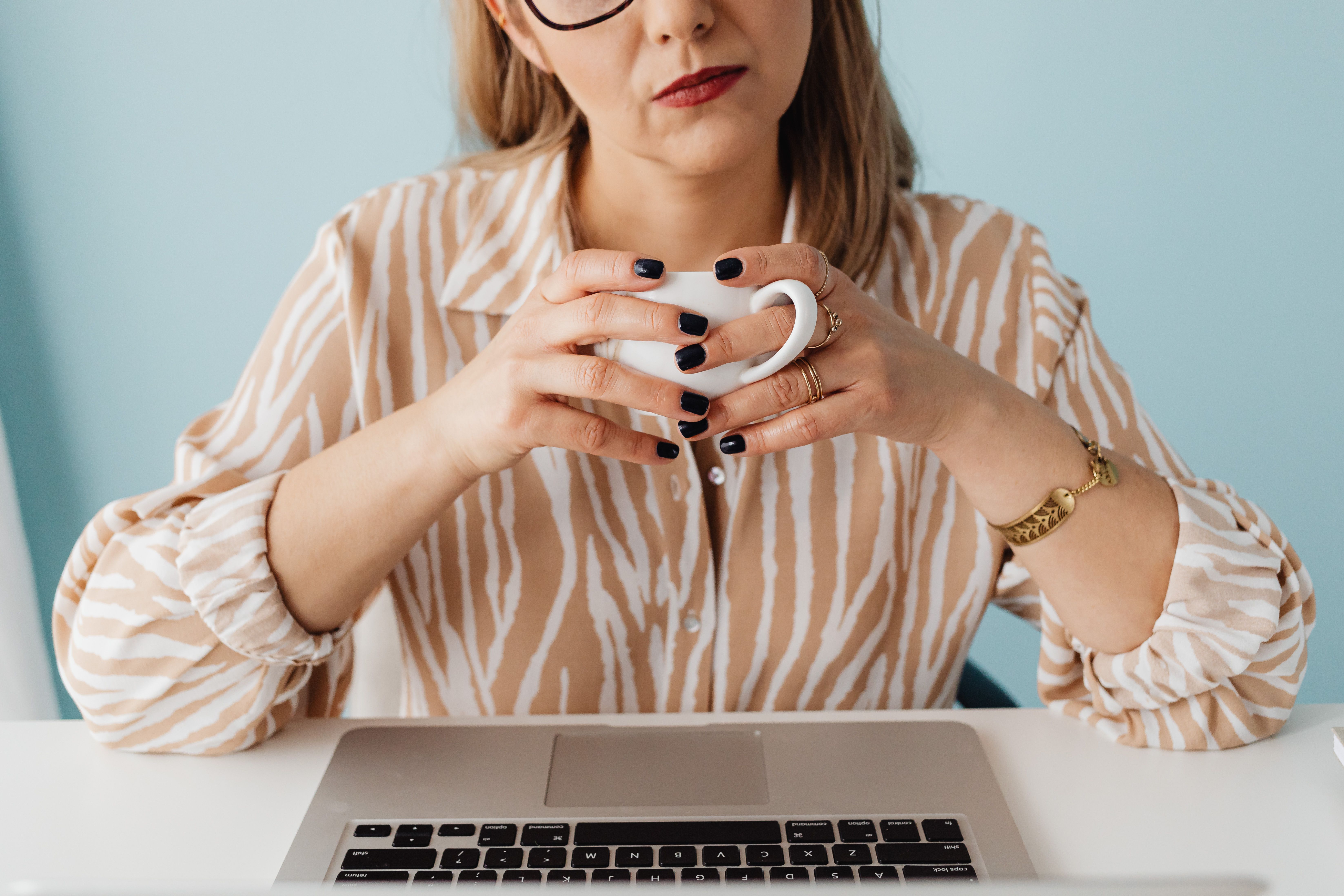 Woman in pinstripe pants with a cream sweater