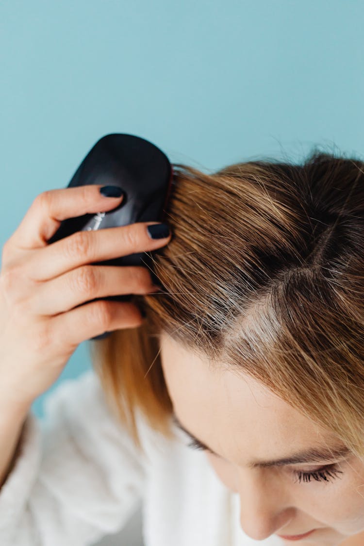 A Woman Brushing Her Hair