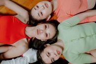 Woman in Red Tank Top Lying on Bed Beside Girl in Red Tank Top