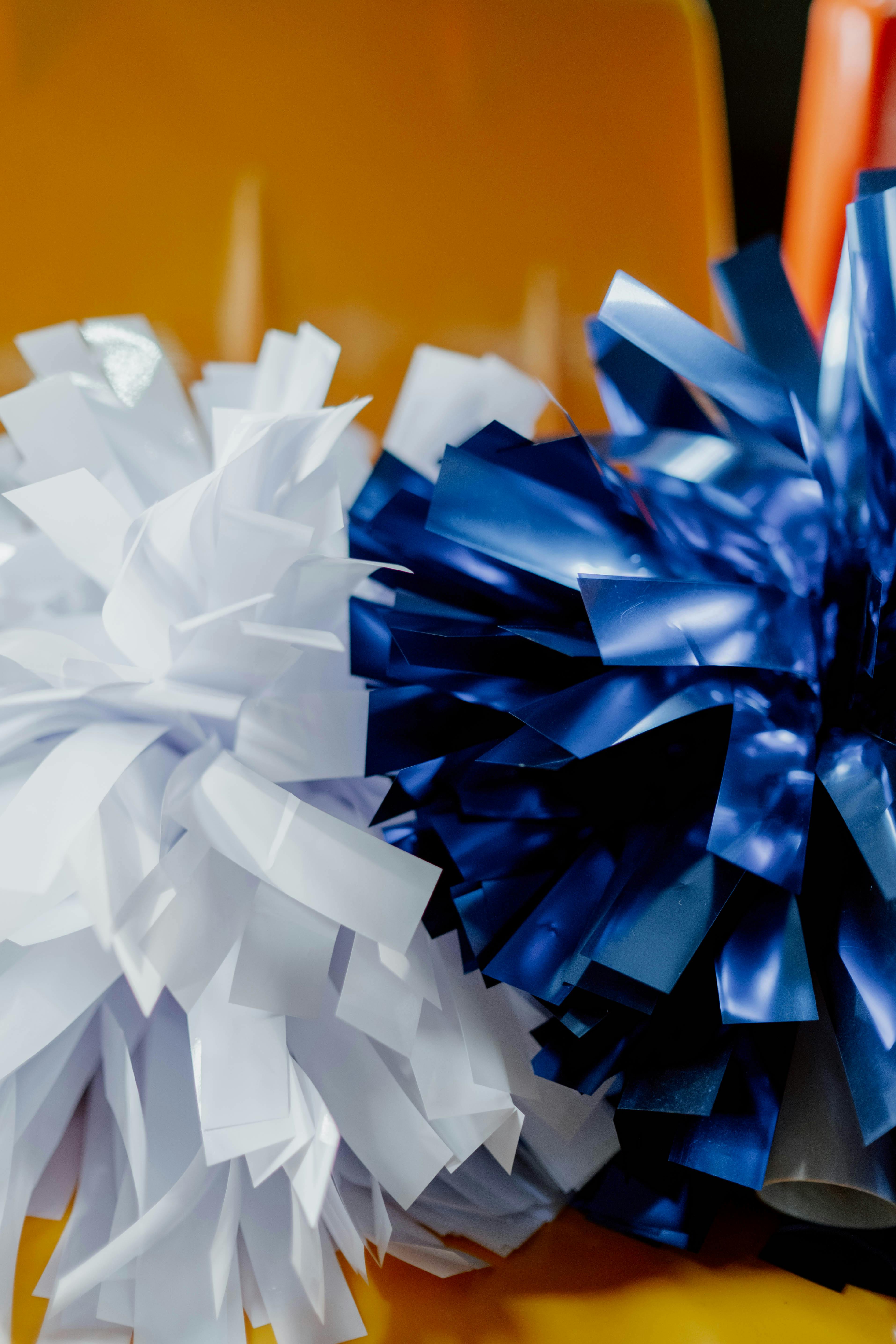 A Close-Up Shot of White and Blue Pompoms · Free Stock Photo