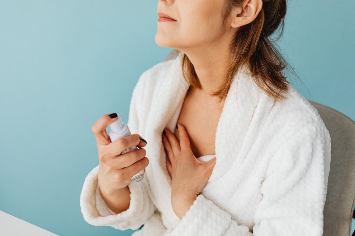 Woman applying a skincare product during a calm beauty routine
