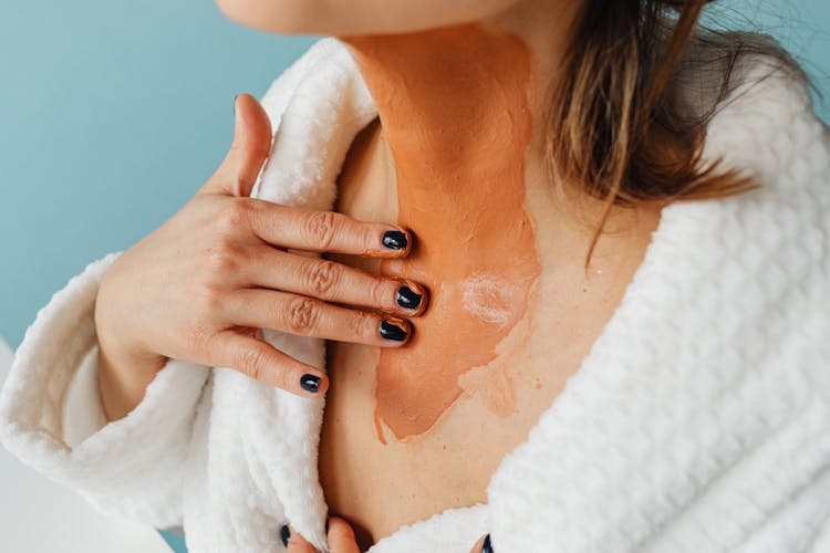 A Woman Applying An Ointment On Her Skin