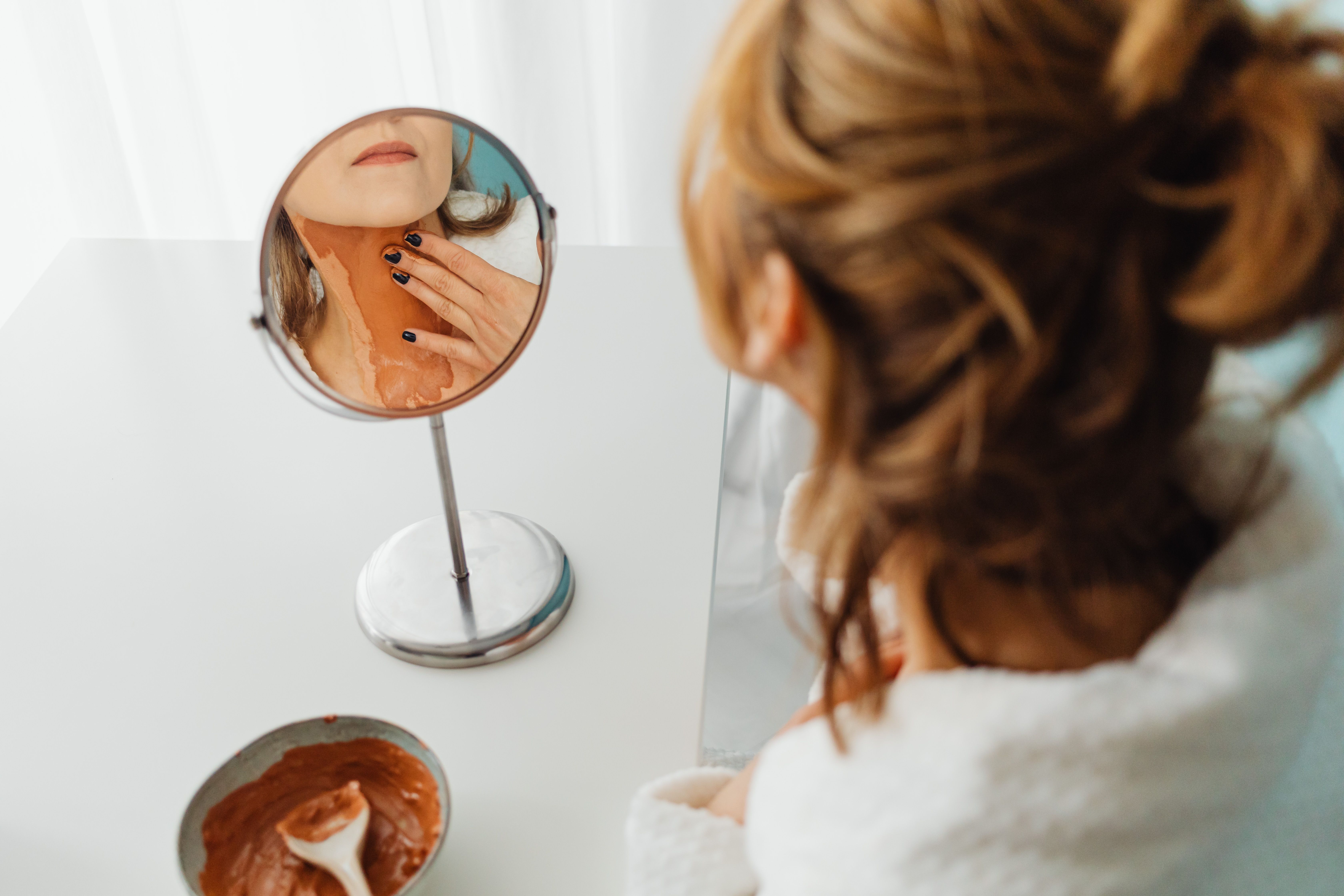 dermatologist applying skincare treatment to patient's neck and décolletage area