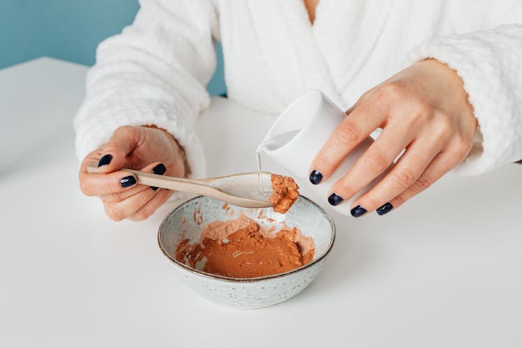 Pouring Water On Spoonful Of Cream