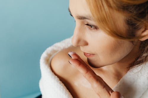 Close-up of Woman Smelling a Cream on Her Fingers 