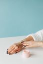 Person Applying Cream on Her Arm