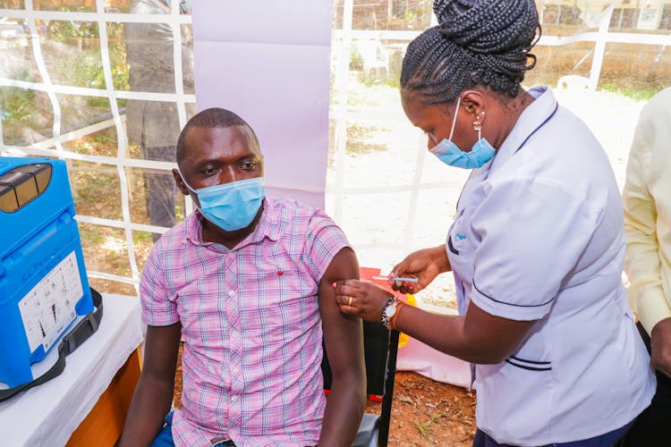 Nurse Vaccinating Man