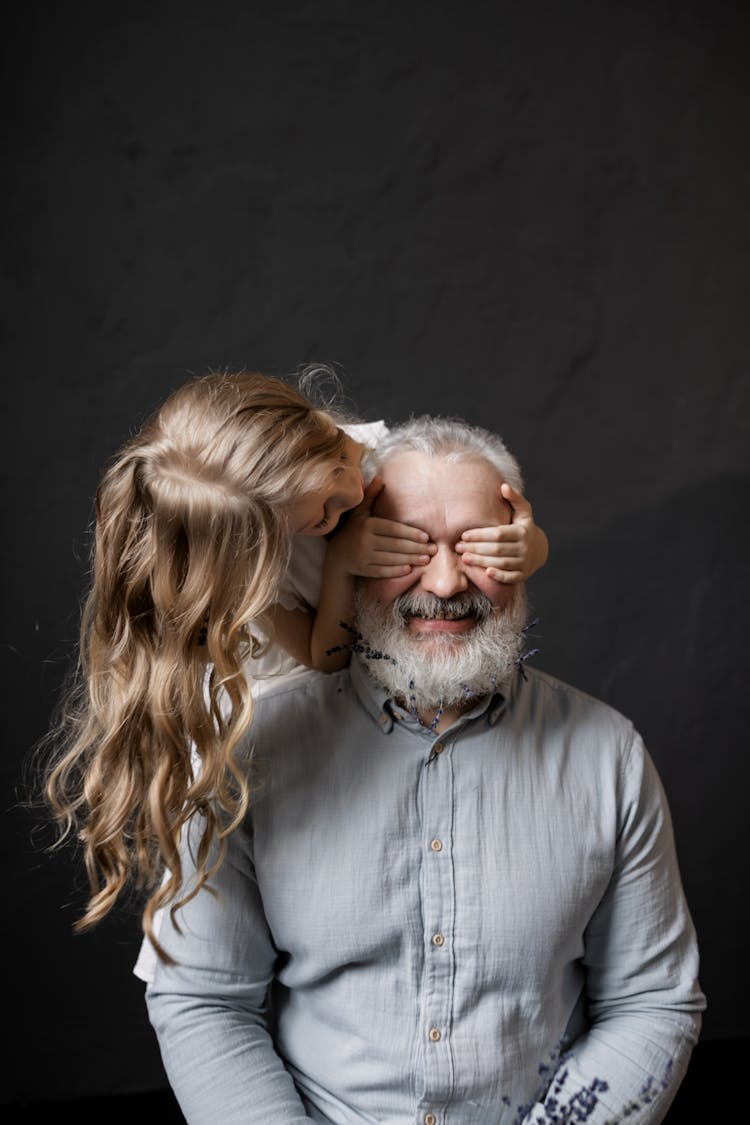 Granddaughter Playing With Her Grandfather