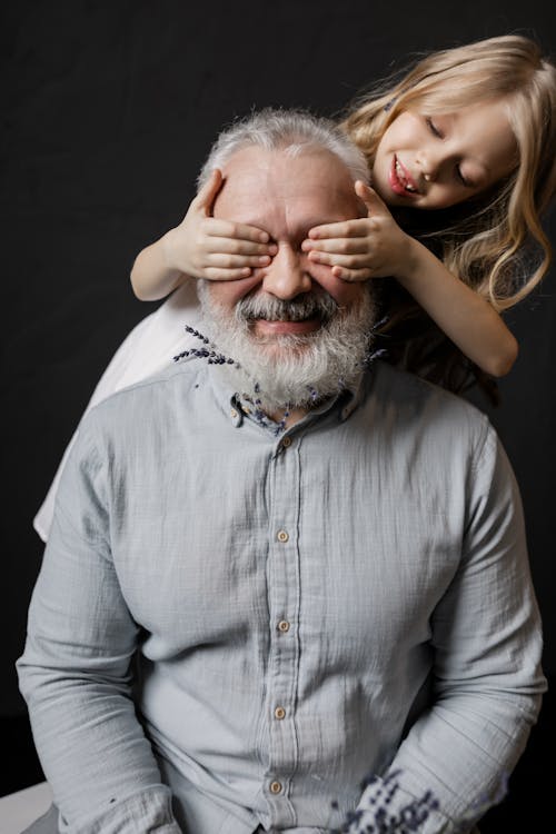 Free Granddaughter Playing with Her Grandfather Stock Photo