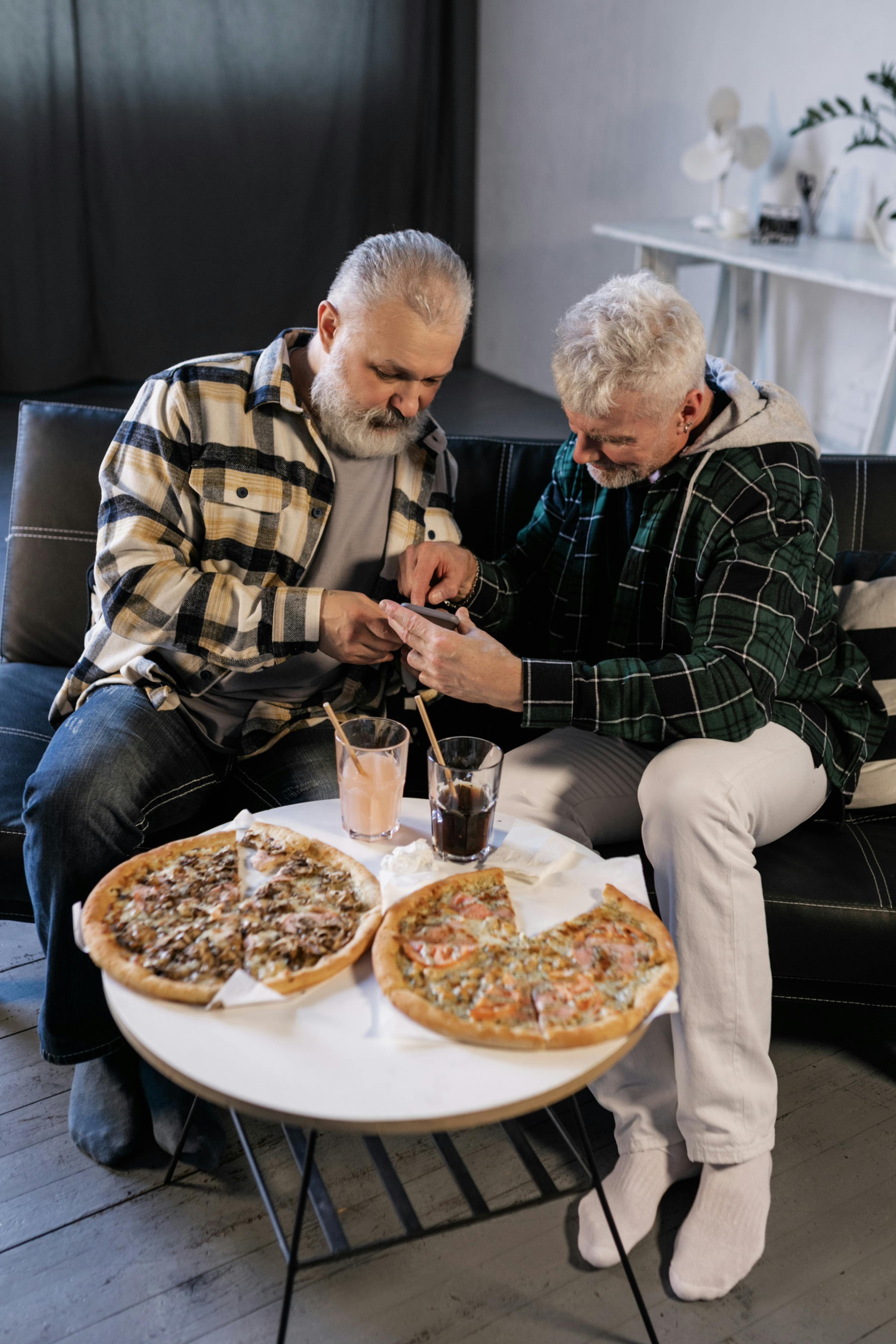 elderly men looking at a smartphone