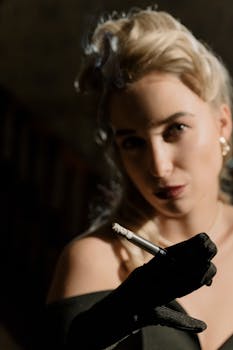 Elegant portrait of a blonde woman holding a cigarette in noir style.