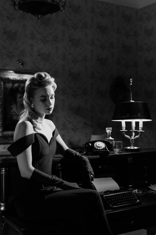 Photo of an Elegant Woman Sitting Beside Counter