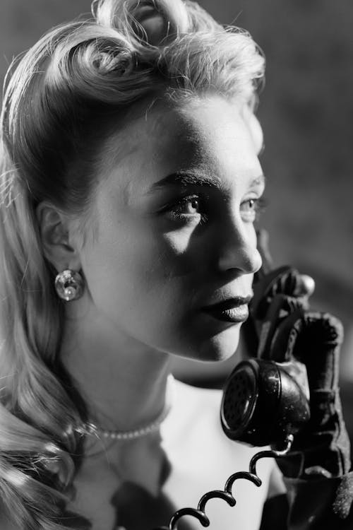 Close-Up Photo of Woman Talking to a Telephone