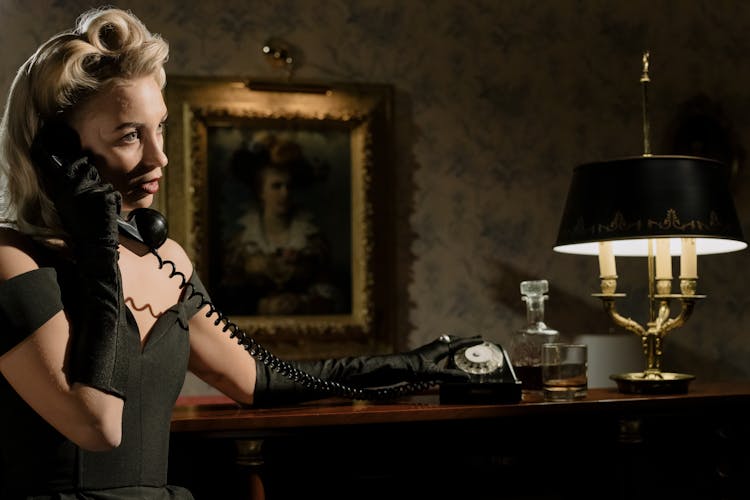 Close-Up Photo Of Woman Talking On A Telephone